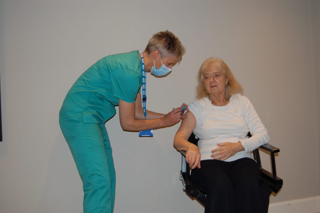 Heather Wallace, CEO of Pain Concern, photographed receiving her shingles vaccination